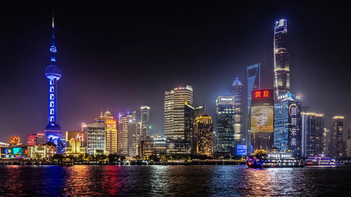 Pudong skyline with the Oriental Pearl Tower lit up across the Huangpu River in Shanghai at night