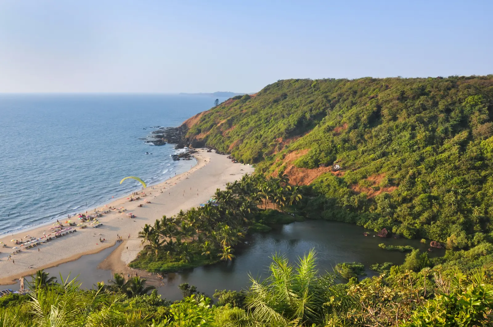 Arambol Beach and its freshwater lake backed by green jungle in North Goa