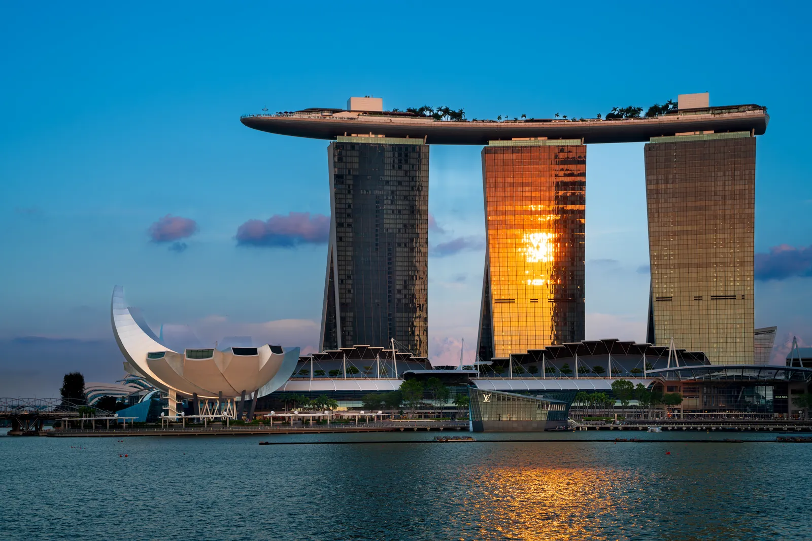 ArtScience Museum lotus building beside Marina Bay Sands at sunset on the waterfront