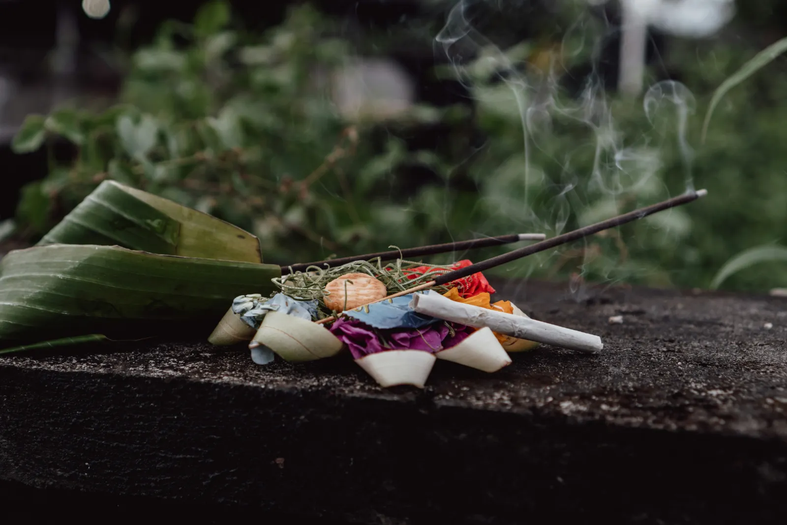 Balinese Hindu offerings with flowers, food and incense placed as a daily prayer