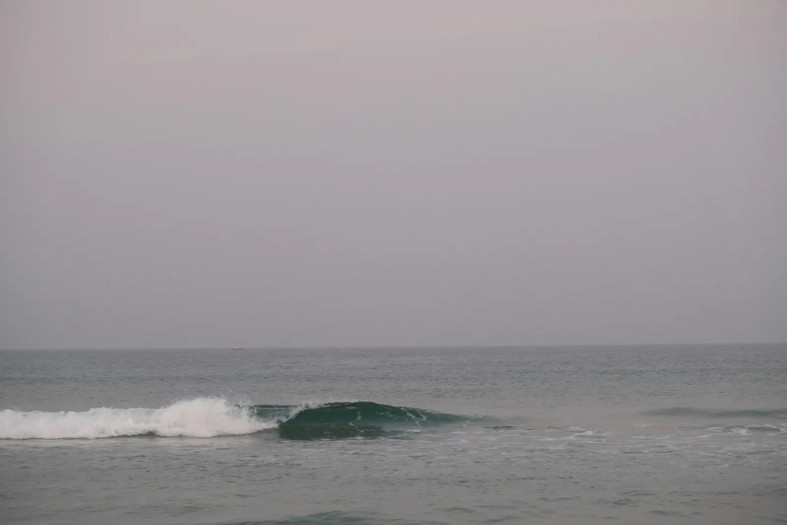 Gentle waves rolling onto the quiet sand at Benaulim Beach in South Goa