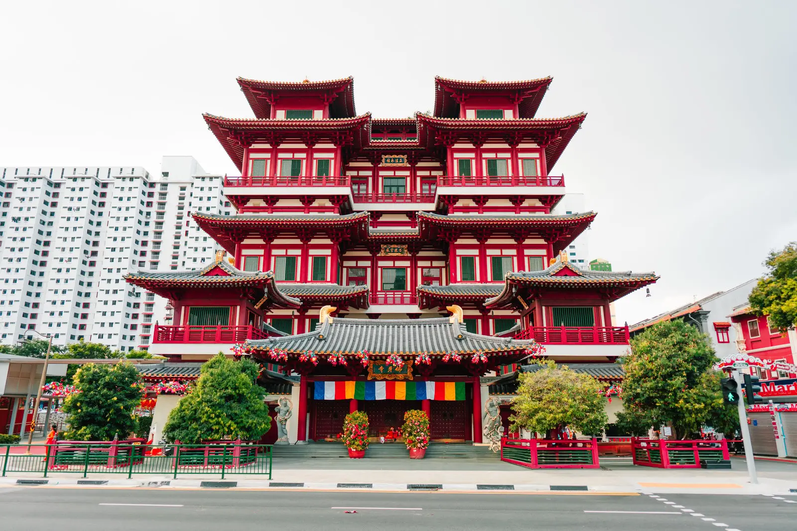 Red and gold facade of the Buddha Tooth Relic Temple on a street in Singapore Chinatown