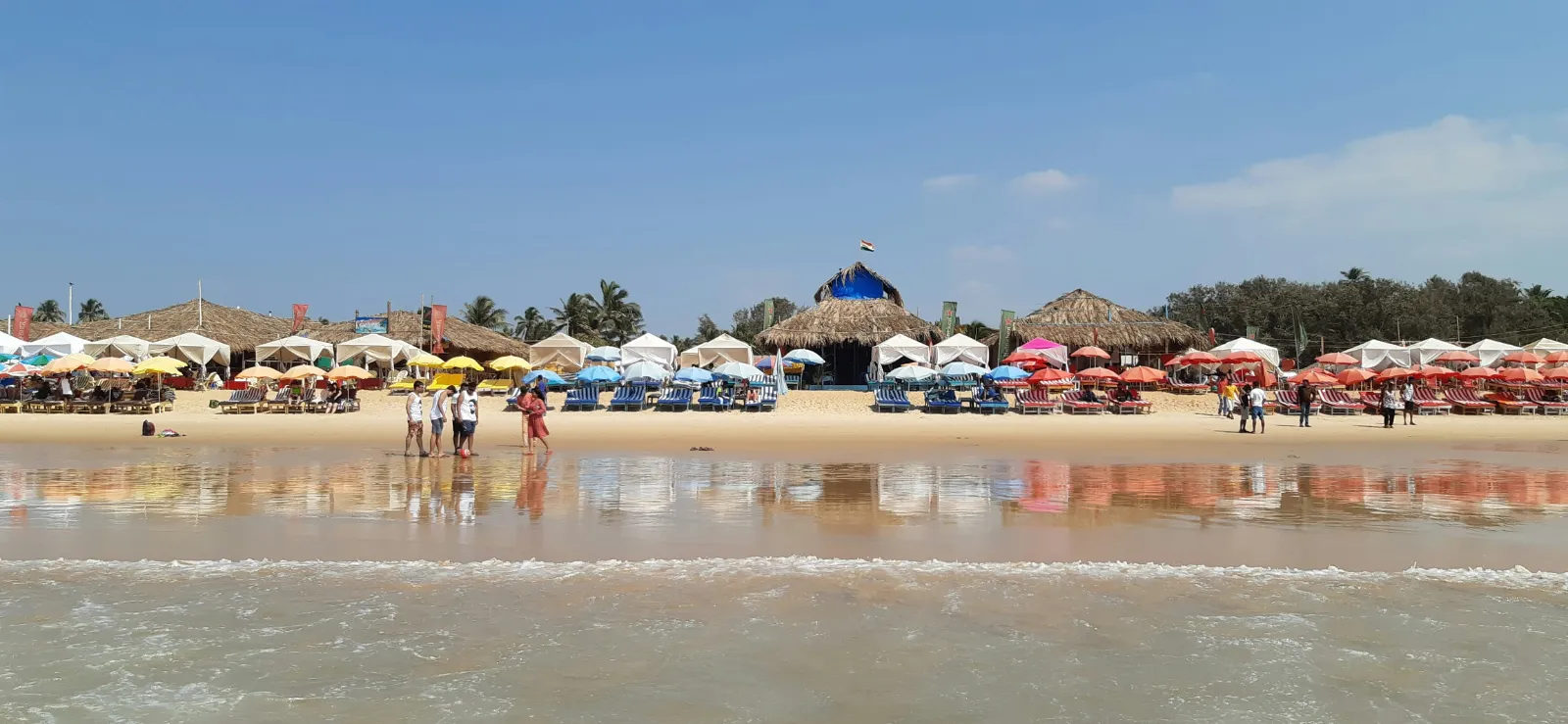 Colourful beach shacks and sunbeds lining the sand at Calangute Beach, Goa
