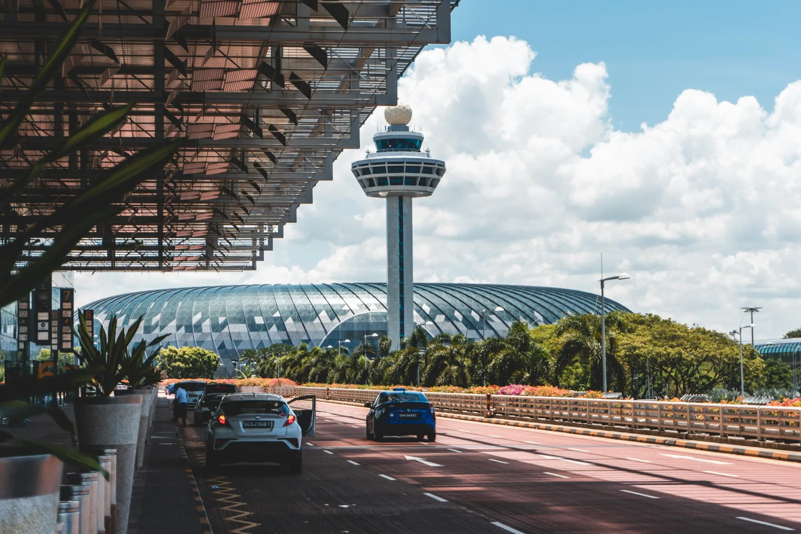 Control tower and terminal roof at Singapore Changi Airport under a bright sky