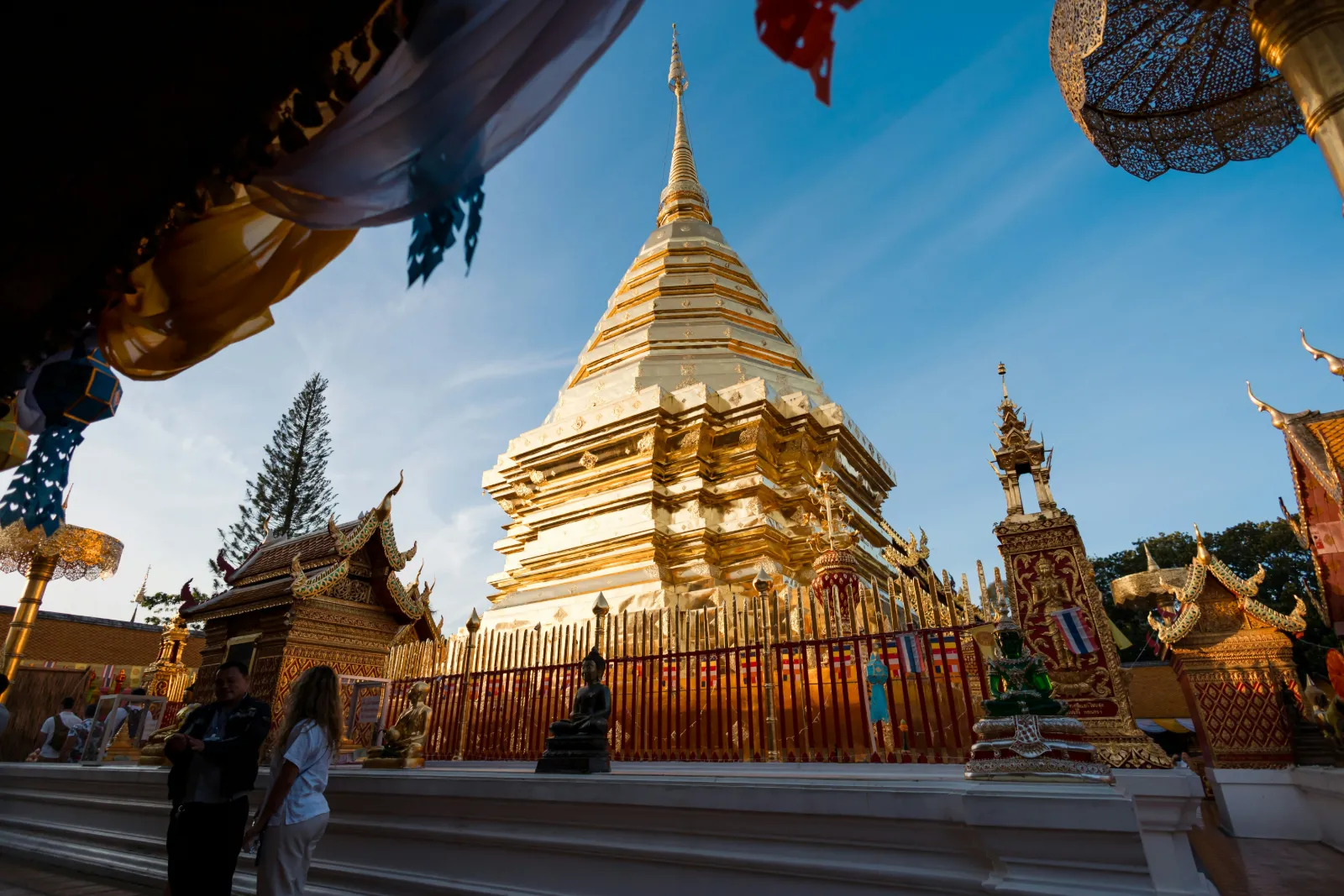 Visitors around the golden chedi of Wat Phra That Doi Suthep above Chiang Mai