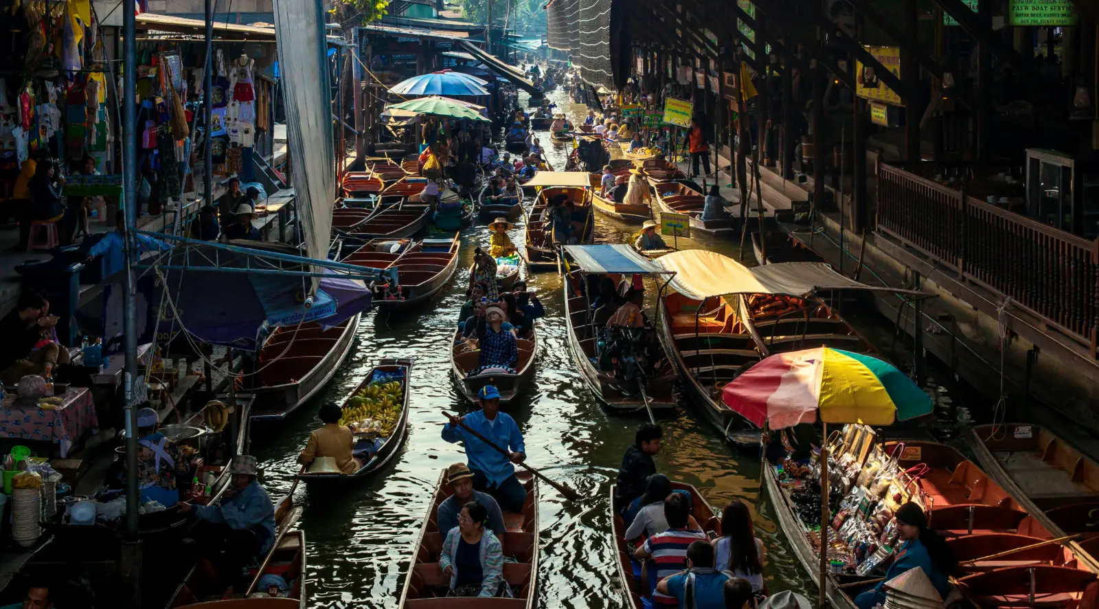 Vendor boats packed along the canal at Damnoen Saduak floating market west of Bangkok
