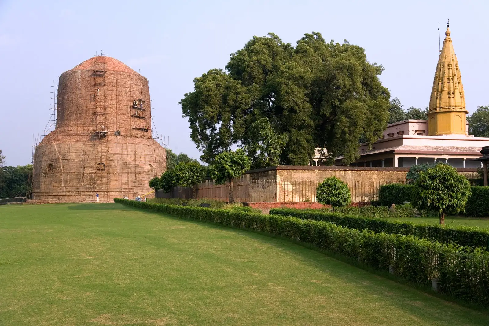 Dhamek Stupa standing on green lawns of the Deer Park at Sarnath near Varanasi