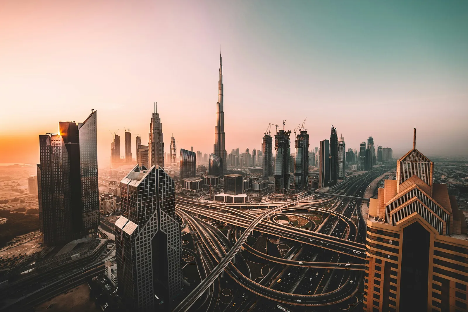 Dubai skyline at golden hour with the Burj Khalifa towering over Sheikh Zayed Road