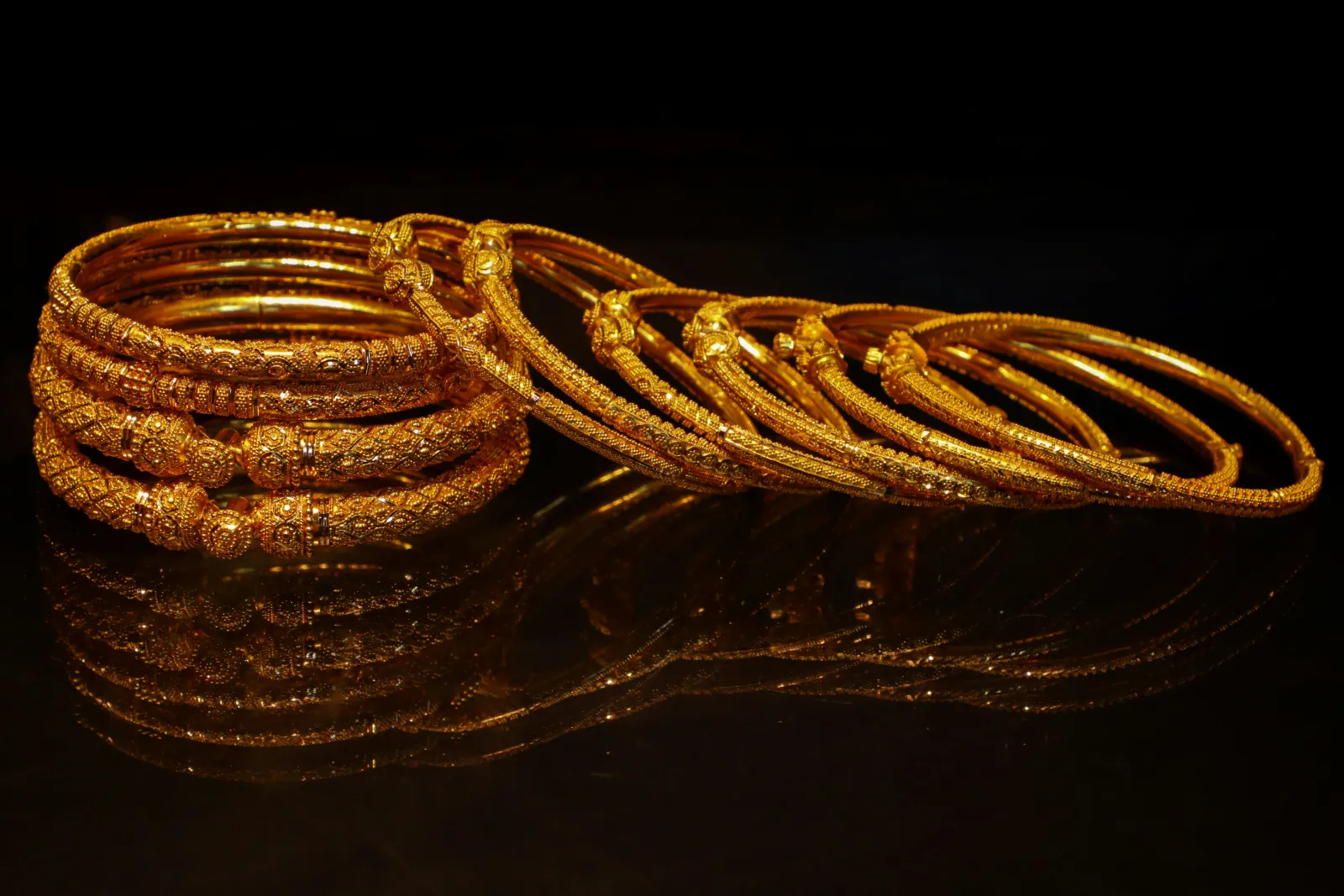 Close view of shiny gold bangles, the kind of piece that carries a purity stamp inside