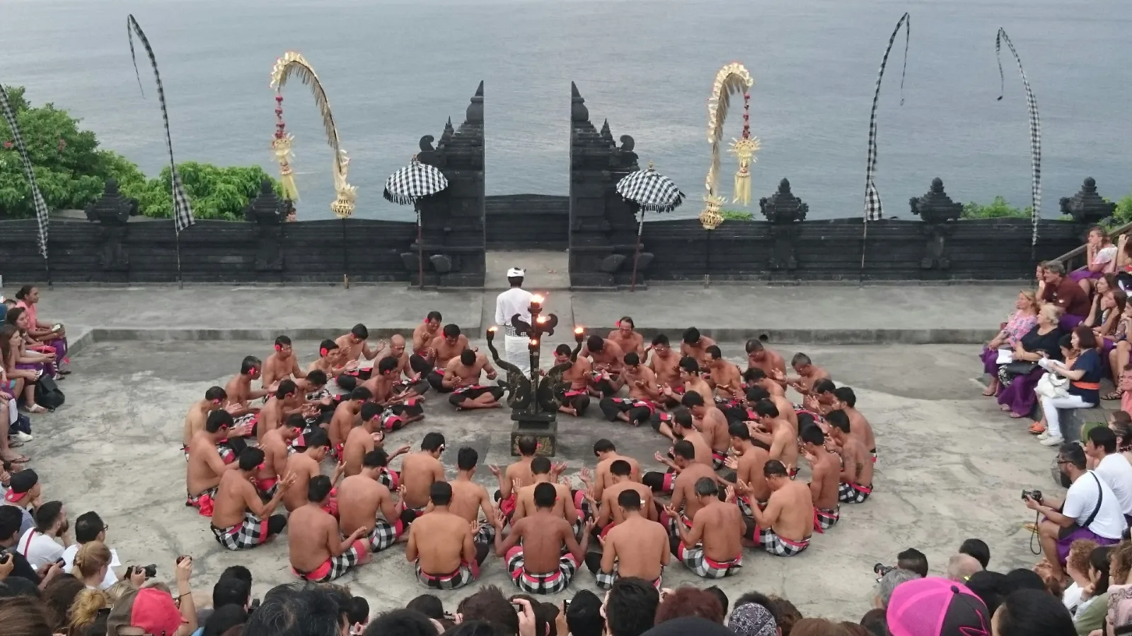 Kecak dancers seated in a large circle at Uluwatu Temple in southern Bali