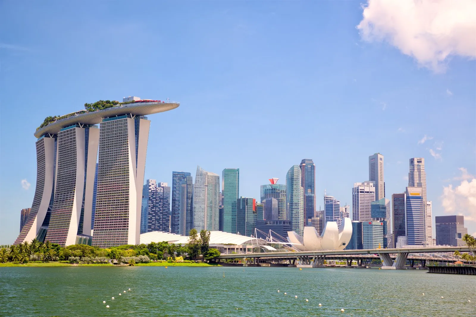Marina Bay Sands towers and the ArtScience Museum beside Marina Bay on a sunny Singapore day