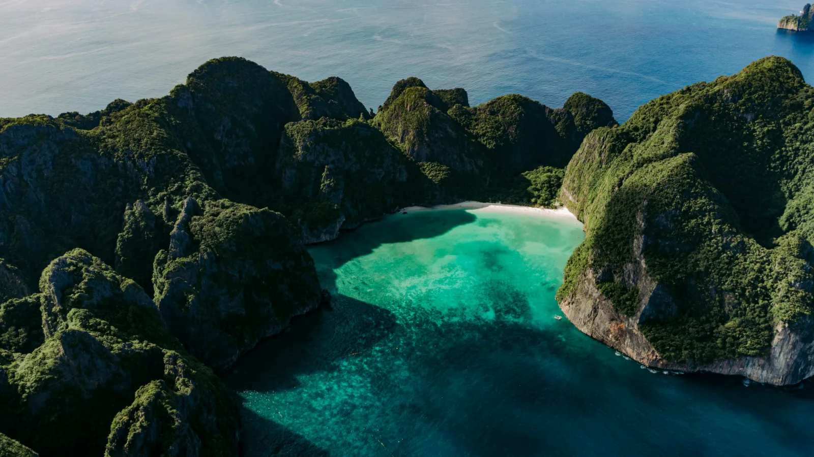 Aerial view of Maya Bay enclosed by steep jungle cliffs on Koh Phi Phi Leh