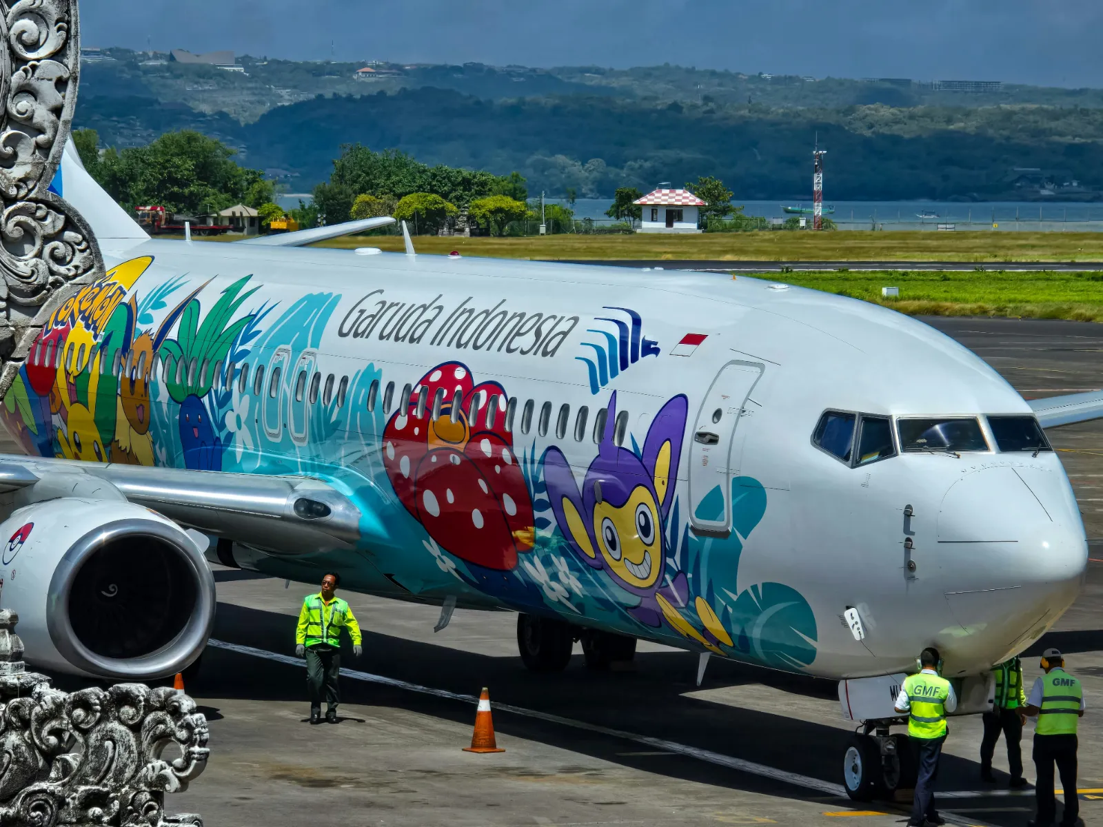 Colourfully painted jet parked on the apron at I Gusti Ngurah Rai International Airport, Bali