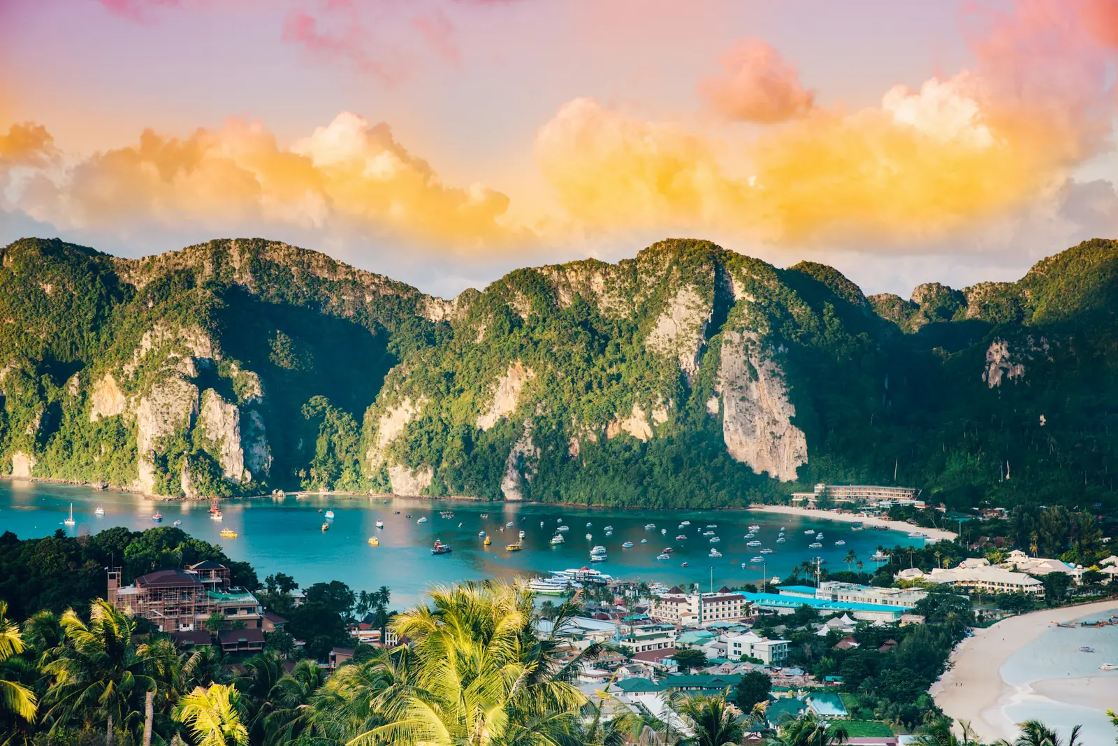 Boats in the bay of Phi Phi Island seen from the viewpoint with green hills behind