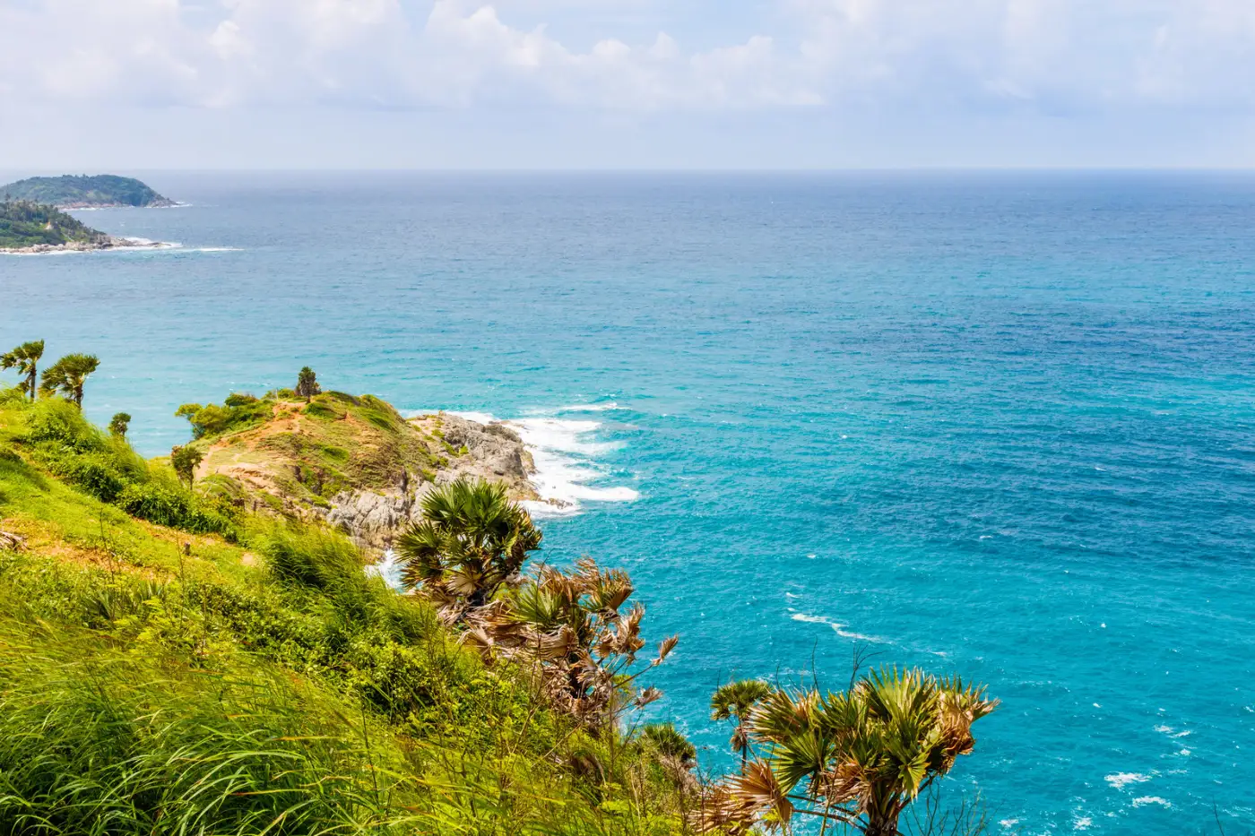 Grassy headland and turquoise Andaman Sea at Phromthep Cape on the southern tip of Phuket