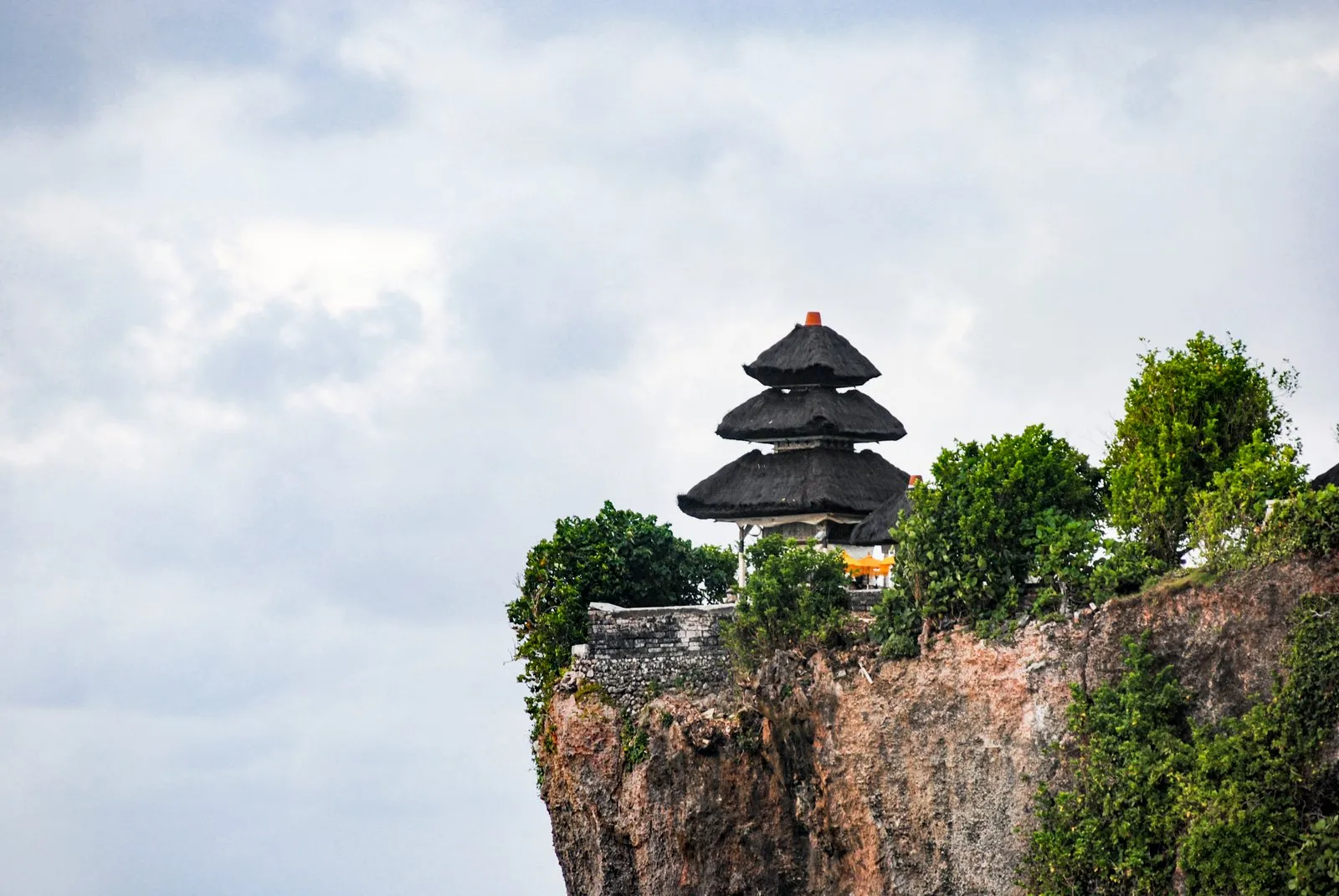 Uluwatu Temple shrine perched on a sheer limestone cliff above the sea in Bali