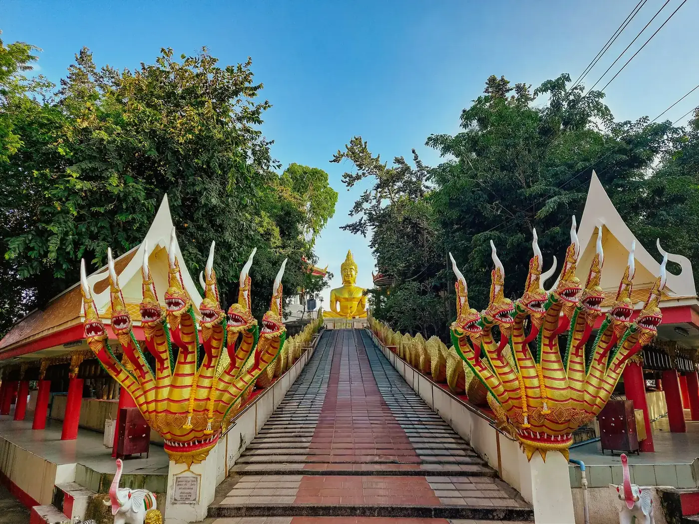Naga lined staircase leading up to the golden Big Buddha at Wat Phra Yai, Pattaya