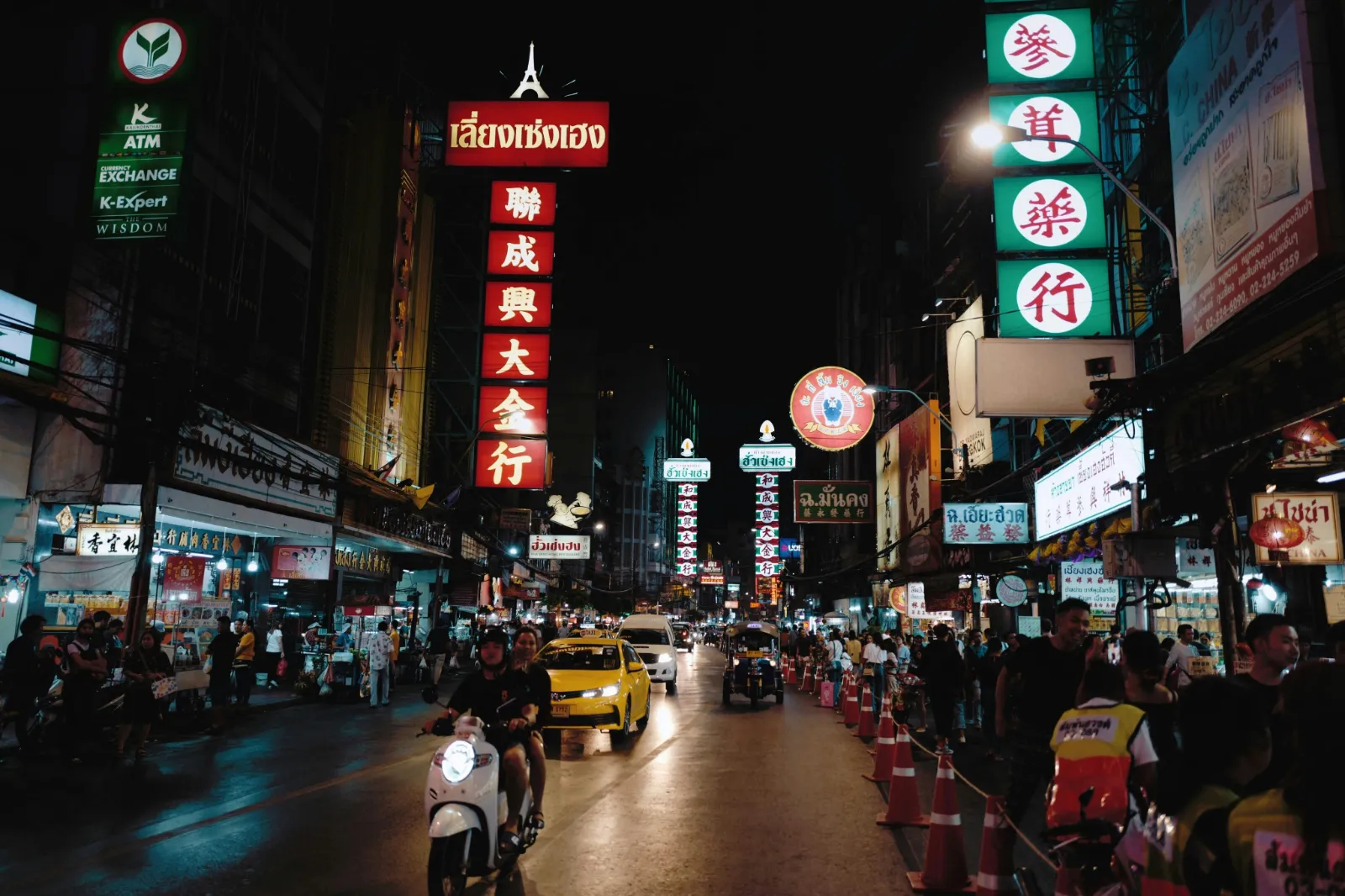 Neon signs and evening traffic along Yaowarat Road in Bangkok Chinatown